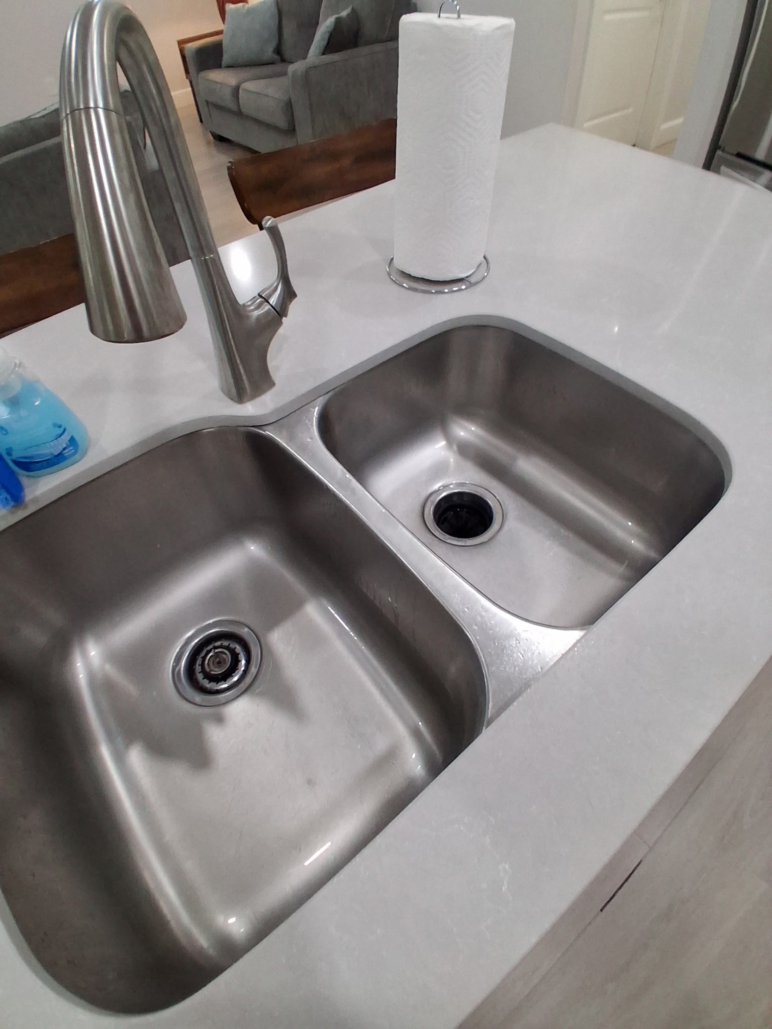 Sparkling stainless steel kitchen sink after professional clean